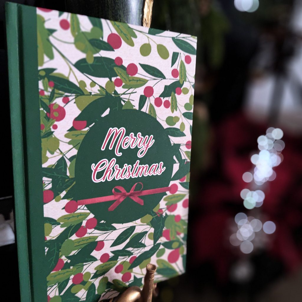 Merry Christmas journal with matte hard cover, festive botanical Christmas design, 120 lined pages
